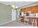 A corner view of the Kitchen featuring light green walls and tile flooring at 761 Vivienda South Ct # 14, Venice, FL 34293