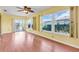 Bright sunroom with wood floors and a large windows overlooking the yard at 761 Vivienda South Ct # 14, Venice, FL 34293