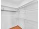 Walk-in Closet with shelves and hanging rods at 761 Vivienda South Ct # 14, Venice, FL 34293
