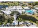 Aerial view of the community clubhouse, golf course, pool, and pond at 782 Harrington Lake N Dr # 99, Venice, FL 34293