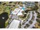 Aerial view of the community clubhouse, golf course, tennis courts, and pool at 782 Harrington Lake N Dr # 99, Venice, FL 34293
