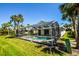 Back exterior featuring a screened in lanai with a swimming pool, patio furniture and manicured lawn at 782 Harrington Lake N Dr # 99, Venice, FL 34293