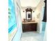 Bathroom featuring a vanity with granite countertops, decorative mirror, and neutral paint at 782 Harrington Lake N Dr # 99, Venice, FL 34293