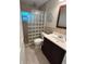 Bathroom with glass block shower, vanity with granite countertop, tile floor and neutral paint at 782 Harrington Lake N Dr # 99, Venice, FL 34293