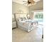 Bedroom featuring a queen bed with tropical floral bedding and access to a private pool at 782 Harrington Lake N Dr # 99, Venice, FL 34293