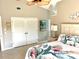 Bedroom featuring a queen bed with tropical floral bedding, ceiling fan, and closet at 782 Harrington Lake N Dr # 99, Venice, FL 34293