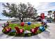 Inviting outdoor community space with colorful chairs, a large tree, and lakeside bites at 782 Harrington Lake N Dr # 99, Venice, FL 34293