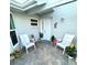 Inviting courtyard entrance featuring a brick-paved patio and seating area, creating a cozy welcome at 782 Harrington Lake N Dr # 99, Venice, FL 34293