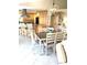Open dining space with island, kitchen, breakfast bar, stylish seating, and decorative lighting at 782 Harrington Lake N Dr # 99, Venice, FL 34293