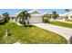 Charming single-Gathering home featuring a well-maintained lawn, complemented by lush landscaping and a two-car garage at 782 Harrington Lake N Dr # 99, Venice, FL 34293