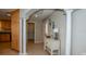 Inviting foyer with tiled flooring, decorative columns, and a charming accent table at 782 Harrington Lake N Dr # 99, Venice, FL 34293