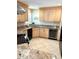Kitchen with granite countertops, tile flooring, light wood cabinets and stainless steel appliances at 782 Harrington Lake N Dr # 99, Venice, FL 34293