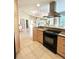 Kitchen with granite countertops, tile flooring, light wood cabinets and stainless steel appliances at 782 Harrington Lake N Dr # 99, Venice, FL 34293