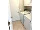 Bright laundry room with white appliances and ample space at 782 Harrington Lake N Dr # 99, Venice, FL 34293