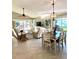 Open living and dining area with tile floors and views of the lanai, creating a bright and inviting space at 782 Harrington Lake N Dr # 99, Venice, FL 34293