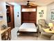 A charming room featuring a Murphy bed, wood built-ins, a desk, and tile flooring at 782 Harrington Lake N Dr # 99, Venice, FL 34293