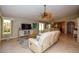 Inviting living room featuring a comfortable seating arrangement, television, and view of the kitchen at 782 Harrington Lake N Dr # 99, Venice, FL 34293