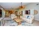Spacious living room with tiled floors, comfortable seating, and an open flow to the dining and kitchen areas at 782 Harrington Lake N Dr # 99, Venice, FL 34293