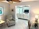 Comfortable living room with a recliner, desk, tile floors, and a view into the Gathering room at 782 Harrington Lake N Dr # 99, Venice, FL 34293