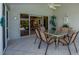 Screened patio with outdoor dining set and view to interior room through sliding glass doors at 782 Harrington Lake N Dr # 99, Venice, FL 34293