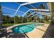 Inviting kidney-shaped pool surrounded by a screened enclosure, offering a private and relaxing outdoor space at 782 Harrington Lake N Dr # 99, Venice, FL 34293