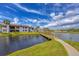 Scenic backyard view with a wooden bridge over the lake at 820 Capri Isles Blvd # 202, Venice, FL 34292