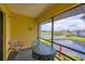 Enjoy serene water views from this screened-in balcony with seating area at 820 Capri Isles Blvd # 202, Venice, FL 34292