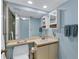 Bathroom with vanity, sink, toilet, wall cabinet, and walk-in shower at 820 Capri Isles Blvd # 202, Venice, FL 34292