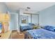 Bedroom featuring a bed, nightstand, window offering beautiful views, and a mirrored closet at 820 Capri Isles Blvd # 202, Venice, FL 34292