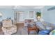Living room featuring muted blue walls, neutral carpet, furniture and a view of the front door at 820 Capri Isles Blvd # 202, Venice, FL 34292