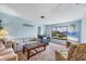Comfortable living room with neutral walls, carpet, furniture and a large window with views at 820 Capri Isles Blvd # 202, Venice, FL 34292