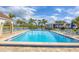 Relax in the community pool surrounded by palm trees and comfortable lounge chairs at 820 Capri Isles Blvd # 202, Venice, FL 34292