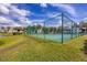 Well-maintained community tennis court with lush green surroundings at 820 Capri Isles Blvd # 202, Venice, FL 34292