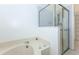 Bright bathroom with a soaking tub, separate glass shower, and tiled walls at 835 Chalmers Dr # 835, Venice, FL 34293
