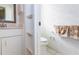Half bathroom adjacent to primary bathroom featuring a toilet, storage shelves, and hanging towels at 835 Chalmers Dr # 835, Venice, FL 34293