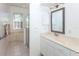 Bright bathroom featuring a bathtub, glass shower, and a vanity with a framed mirror at 835 Chalmers Dr # 835, Venice, FL 34293