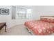 Inviting bedroom features a bay window, neutral carpet and stylish bedspread at 835 Chalmers Dr # 835, Venice, FL 34293