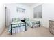Light-filled bedroom with twin beds dressed in colorful floral patterns, complemented by light carpeting at 835 Chalmers Dr # 835, Venice, FL 34293
