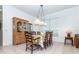 Traditional dining area with detailed display cabinet and natural lighting at 835 Chalmers Dr # 835, Venice, FL 34293