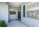Charming entryway featuring decorative wreath, a large window and black front door at 835 Chalmers Dr # 835, Venice, FL 34293