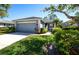 Well-maintained single-story home with a two-car garage, neat landscaping, and a concrete driveway at 835 Chalmers Dr # 835, Venice, FL 34293