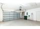 Spacious garage with an automatic door, concrete floors, and ample storage space at 835 Chalmers Dr # 835, Venice, FL 34293