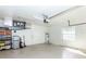 Bright and organized garage featuring storage shelves, a water heater, and concrete flooring at 835 Chalmers Dr # 835, Venice, FL 34293