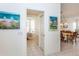 Hallway leading to a dining area with lots of light; artwork featured at 835 Chalmers Dr # 835, Venice, FL 34293