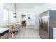 Bright kitchen with stainless steel refrigerator, breakfast nook, and passthrough to the living and dining areas at 835 Chalmers Dr # 835, Venice, FL 34293
