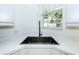 Close up of the modern sink and faucet with view from the kitchen window at 835 Chalmers Dr # 835, Venice, FL 34293