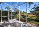 Enjoy the outdoors bug-free from this screened lanai with comfortable seating and a beautiful view of the lush greenery at 835 Chalmers Dr # 835, Venice, FL 34293