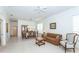 Open-concept living area with carpet, leading to the dining room and hall at 835 Chalmers Dr # 835, Venice, FL 34293