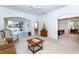 Bright living room featuring an open floor plan, archways, a ceiling fan and glass sliding doors to the outdoors at 835 Chalmers Dr # 835, Venice, FL 34293