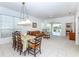 Open-concept living room with dining area offers ample natural light and neutral decor at 835 Chalmers Dr # 835, Venice, FL 34293